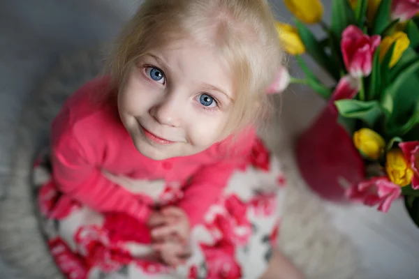 Porträt eines schönen kleinen Mädchens mit Blumen — Stockfoto