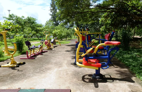 Kleurrijke Outdoor Fitnessapparaten Het Park Zijn Weelderig Veel Groene Bomen — Stockfoto