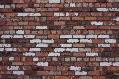 Kahverengi, kırmızı ve beyaz karışık tuğla duvar. Katı renkli tuğla bina duvarı yakın plan.