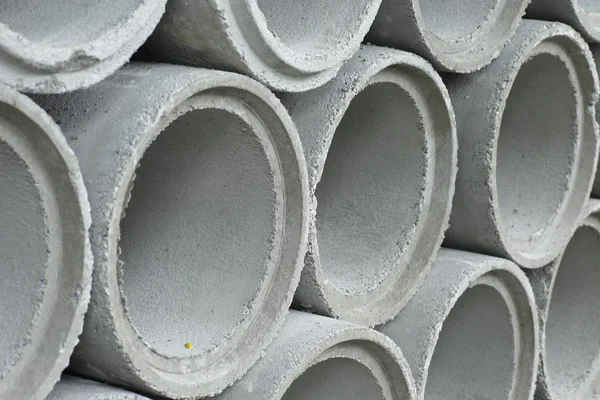 Tubos de drenaje de hormigón apilados en el sitio de construcción — Foto de Stock