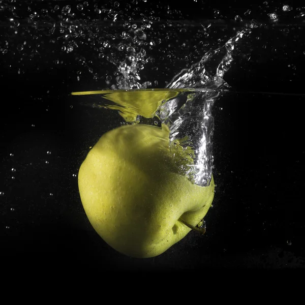 Apple splash in water on black — Stock Photo, Image