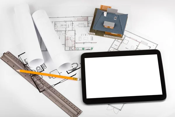 Blank tablet and house scale model on architectural blueprints — Stock Photo, Image