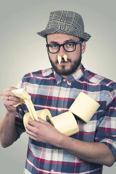 Runny nose - unhappy sick man with tissues in nose — Stock Photo, Image