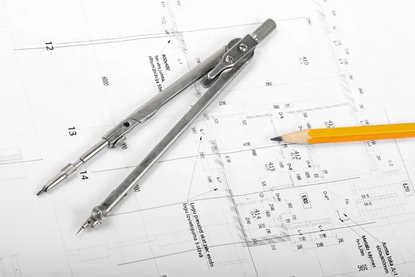 Divider and pencil on architectural blueprints — Stock Photo, Image