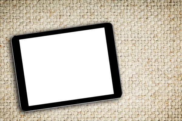 Tom digital tablet på tyg bakgrund — Stockfoto