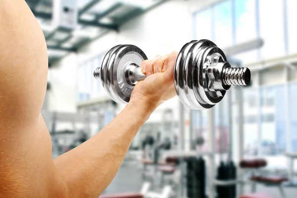 Gym. man with dumbbell in the hand — Stock Photo, Image