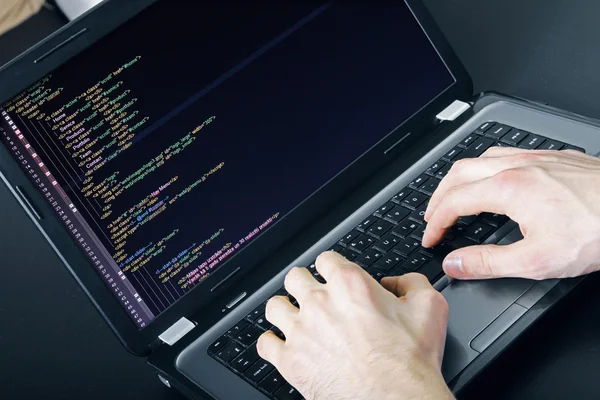 Programmer occupation - writing programming code on laptop — Stock Photo, Image