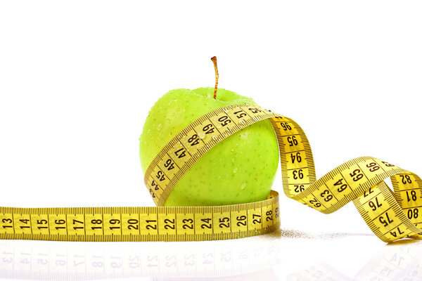 diet, healthy nutrition concept. apple with measuring tape