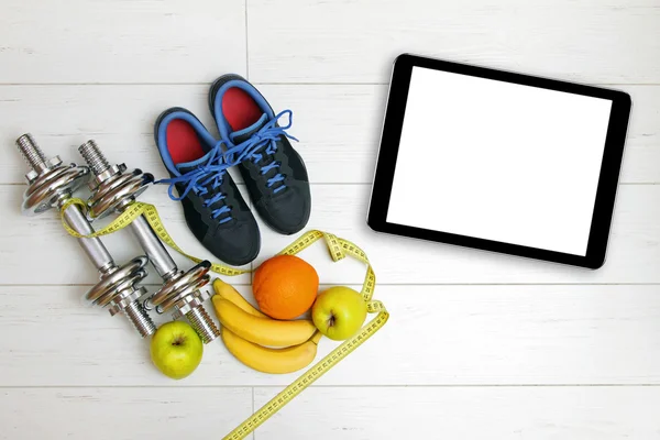 Fitness equipment and fruits on white wooden plank floor — Stock Photo, Image