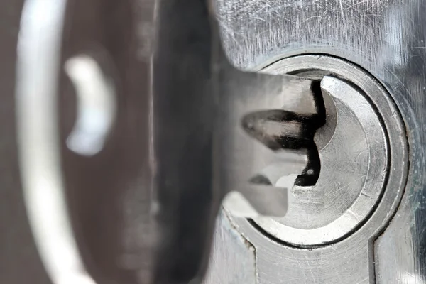 Macro shot of door lock keyhole with key — Stock Photo, Image