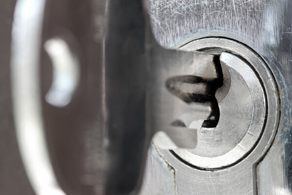 macro shot of door lock keyhole with key