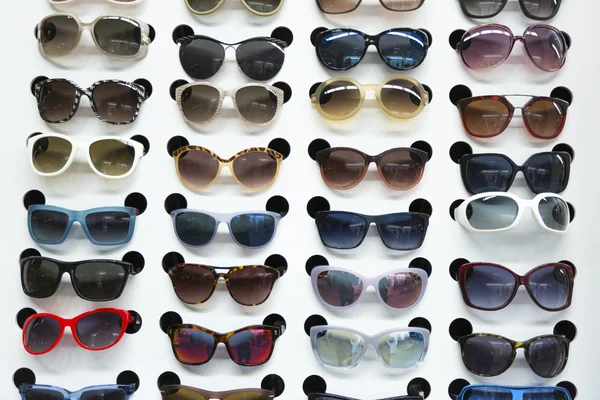 Rack with sunglasses in eyewear store — Stock Photo, Image