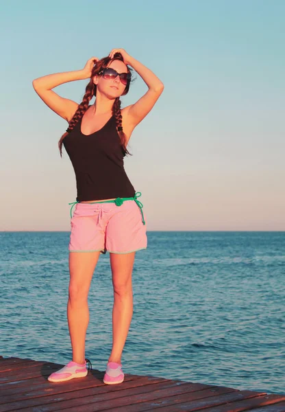 Young girl sunbathe on bridge Stock Photo