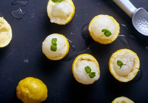 Lemon sorbet or ice cream inside fresh lemons — Stock Photo, Image