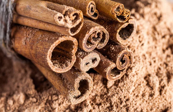 Cinnamon sticks on powder — Stock Photo, Image