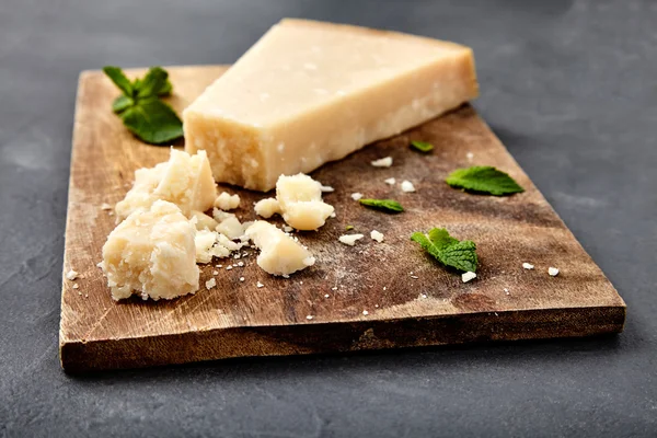 Piece of a parmesan and grated cheese — Stock Photo, Image