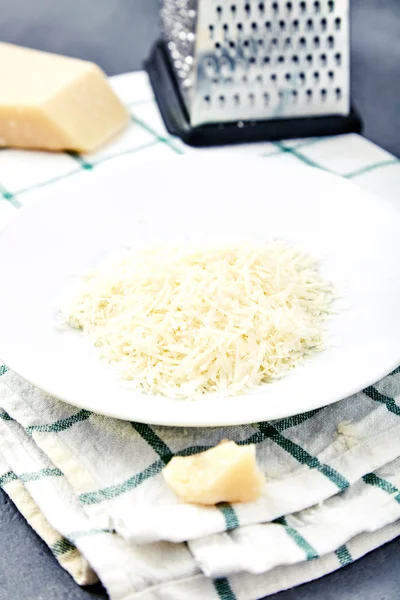 Piece of a parmesan and grated cheese