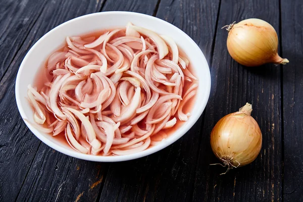 Pickled onion on wooden background