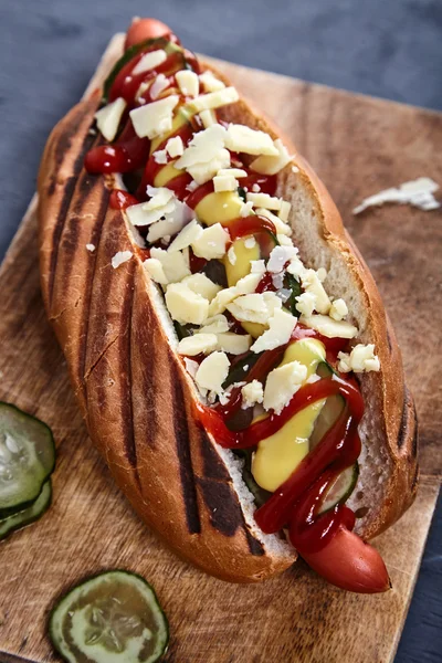 stock image Hot dog with pickles, ketchup, mustard and cheese