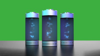 İçinde elektrik yükü olan silindirik piller yeşil ekranda izole edilmiş.