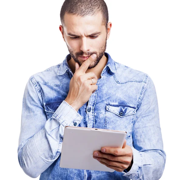 Вдумчивый человек смотрит на свой цифровой планшет — стоковое фото