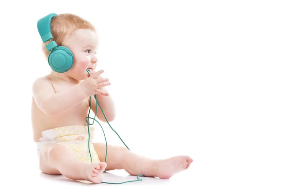 Bebê brincando com fones — Fotografia de Stock