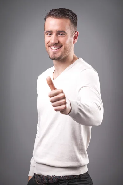 Smiling casual guy showing thumbs up — Stock Photo, Image