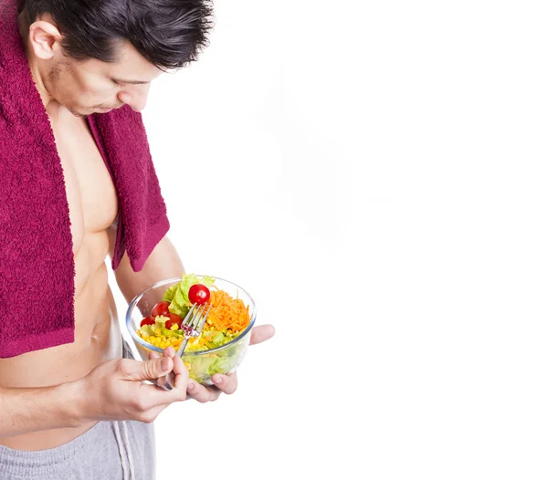 Fit man holding a bowl of salad — Stock Photo, Image