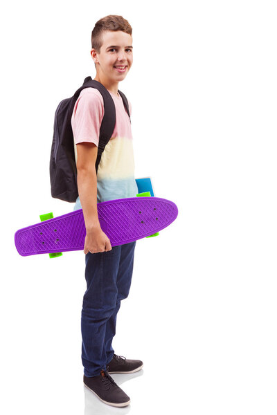 school boy holding a skateboard and notebooks