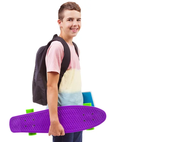 School boy holding a skateboard and notebooks — Stock Photo, Image