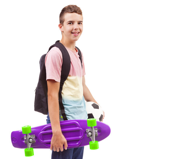 school boy holding a skateboard and a soccer ball