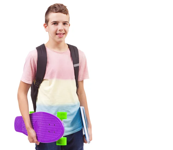 Menino da escola segurando um skate e cadernos — Fotografia de Stock