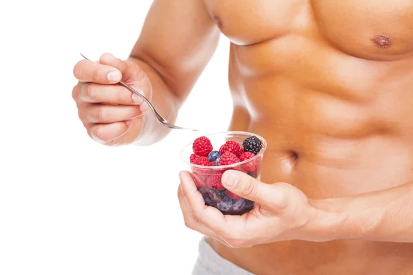 Fit man holding a bowl of fresh fruits — Stock Photo, Image