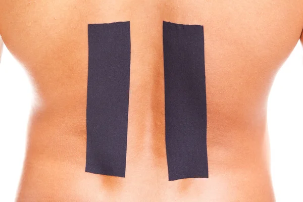 Hombre muscular con kinesiotaping en la parte inferior de la espalda —  Fotos de Stock