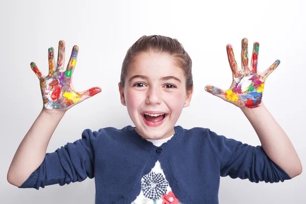 Girl with arms raised showing painted hands — Stock Photo, Image