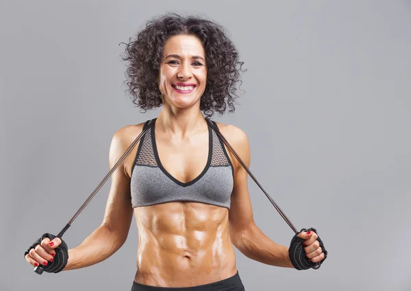 Smiling fitness woman with jumping rope — Stock Photo, Image