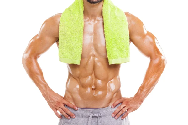 Uomo muscolare in posa con asciugamano verde — Foto Stock
