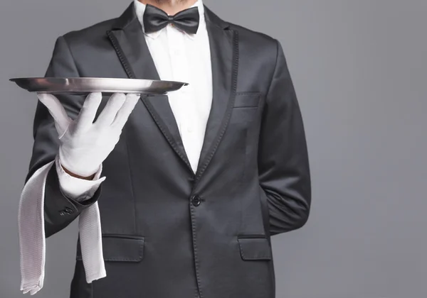 Butler holding a silver tray — Stock Photo, Image