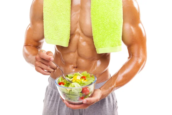 Hombre musculoso sosteniendo un tazón de ensalada —  Fotos de Stock