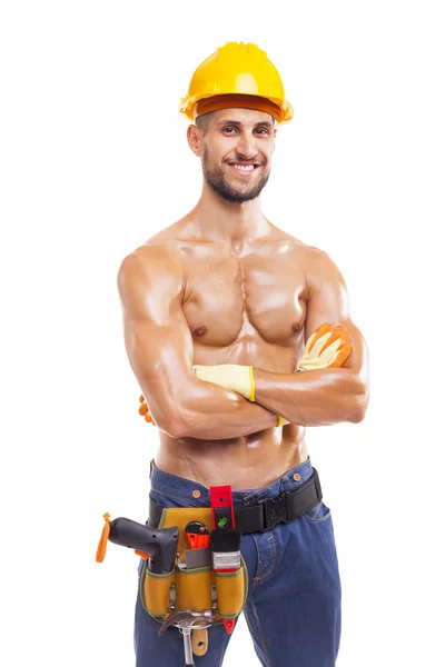 Leende muskulös arbetare med armarna korsade — Stockfoto