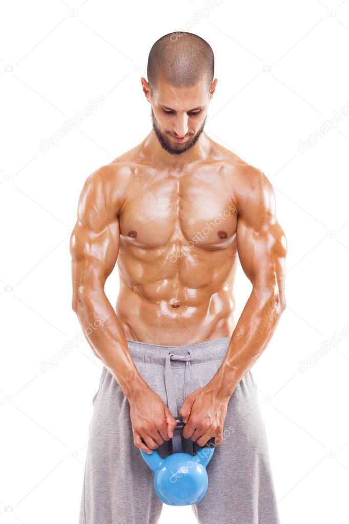 Fit young man lifting a kettlebell