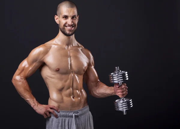 Homem muscular levantando pesos — Fotografia de Stock