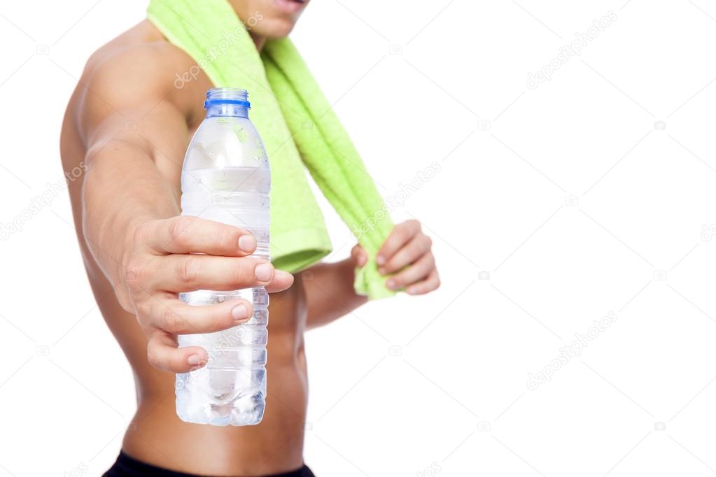 Fitness man holding a bottle of water, isolated on white backgro