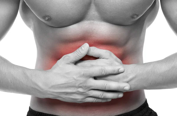 Young man holding his stomach in pain — Stock Photo, Image