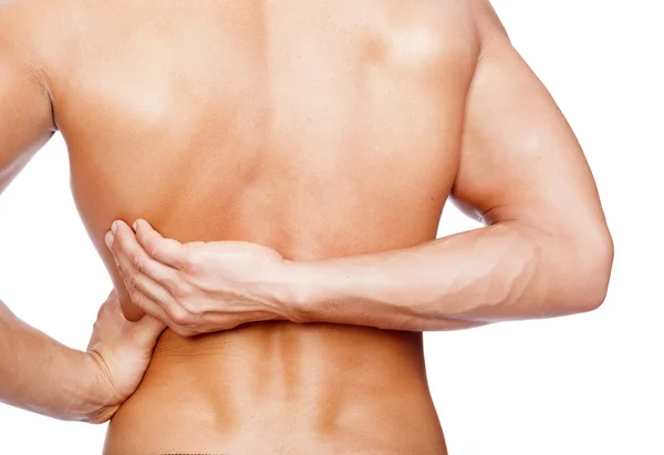 Young man holding his back in pain — Stock Photo, Image