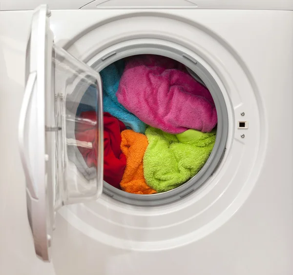 Wash machine with colored clothes inside — Stock Photo, Image