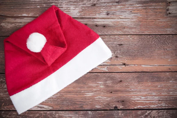 Santa claus hat on a wooden background — Stock Photo, Image