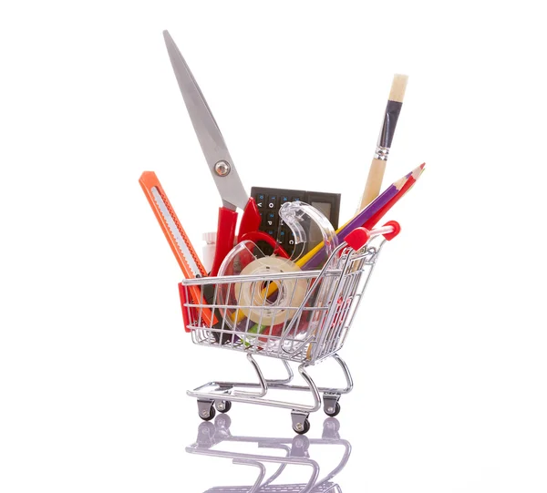 Shopping cart full of school material, isolated on white backgro — Stock Photo, Image