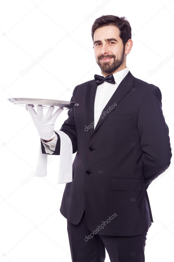 Portrait of handsome waiter holding an empty tray