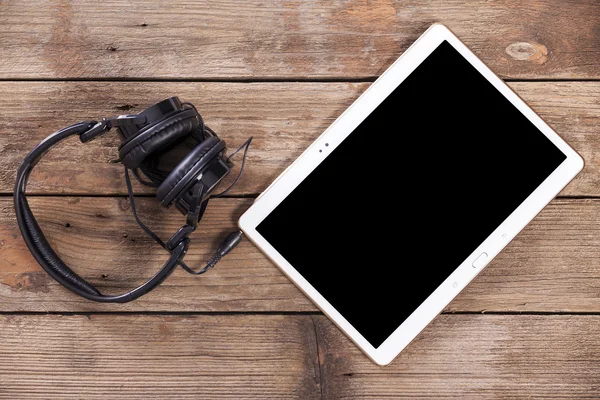 Tablet computer with headphones — Stock Photo, Image